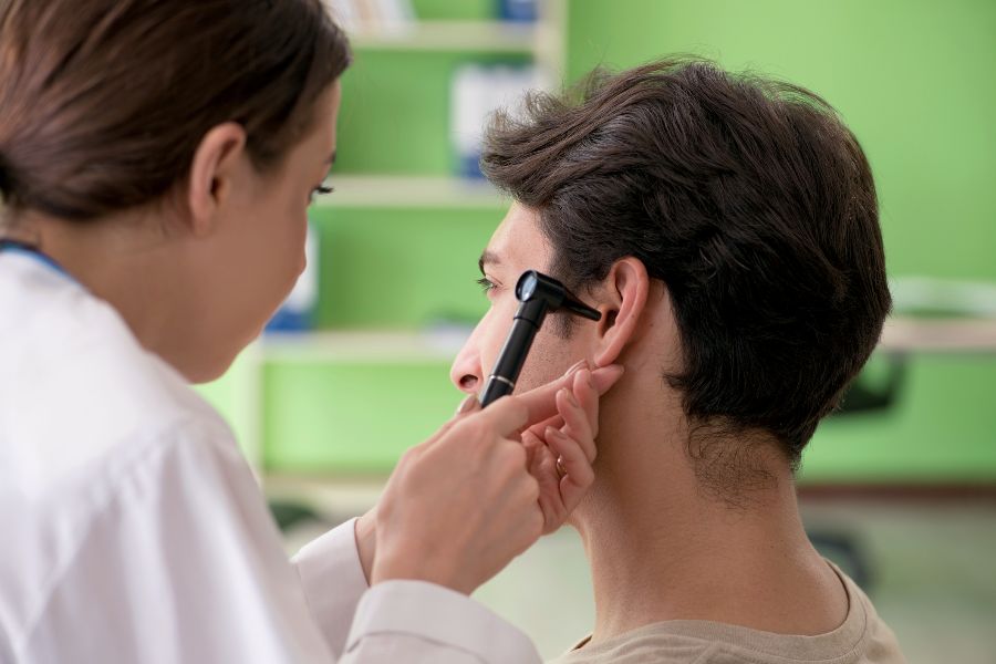 A doctor checking a patient's ear